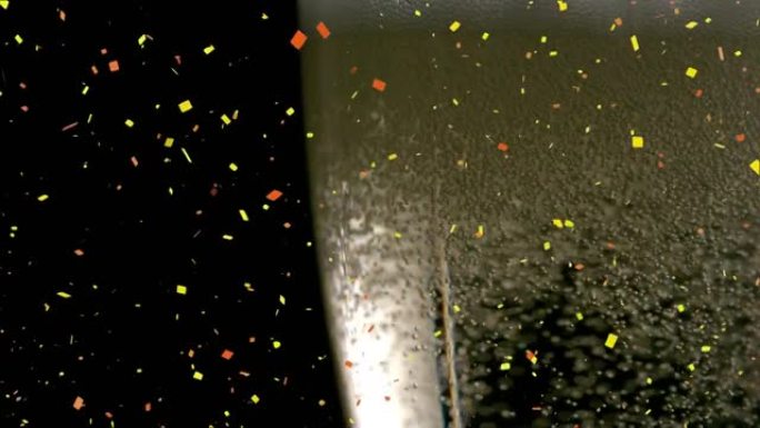 黑色背景上的香槟杯中五彩纸屑掉落和气泡上升的动画