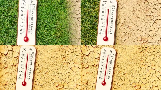 绿草背景上的温度计随着干旱干燥土壤地面裂缝的变化而变化