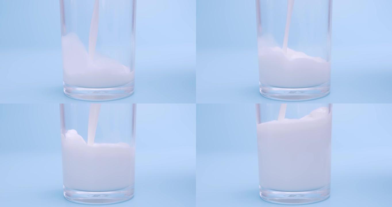 将新鲜牛奶倒在蓝色背景上。