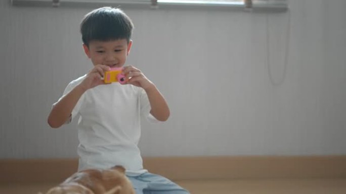 亚洲男孩在家与柯基狗一起喂食，玩耍和拍照
