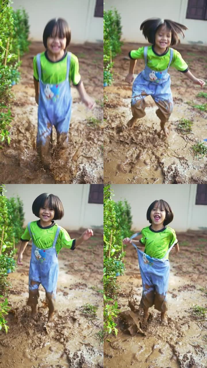小女孩在非常泥泞的水坑里跳进水坑。