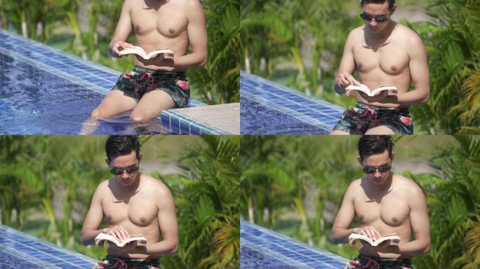 SLO MO-Man在游泳池放松和阅读书籍
