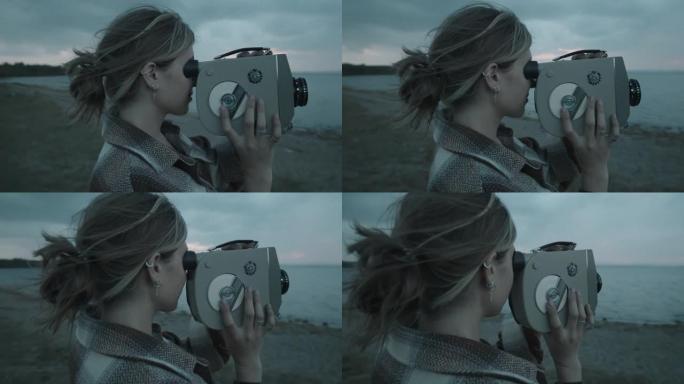 女人在湖岸用老式相机拍摄视频