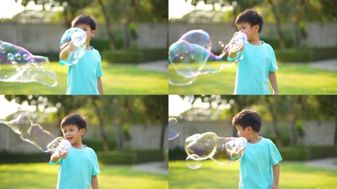 亚洲孩子在公园玩泡泡。幸福与夏天的概念