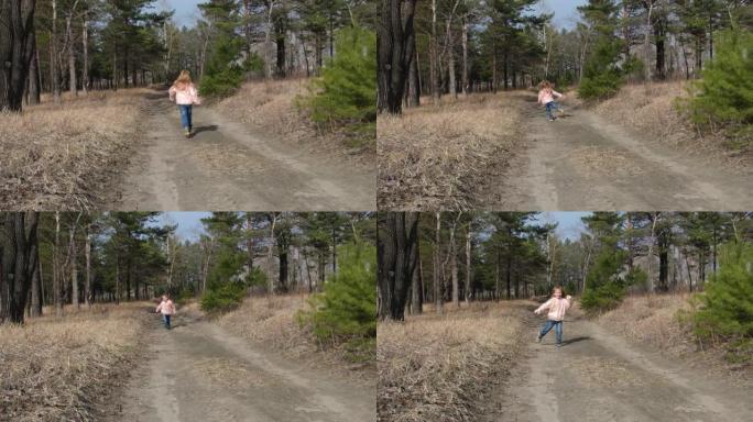 玩得开心。童女在森林里沿着小路奔跑，跳跃和跳舞，活跃的户外游戏。。慢动作