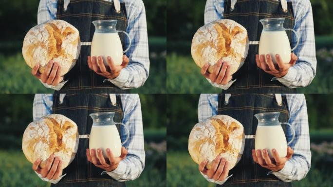一个农民拿着一壶牛奶和一条洛巴面包。健康有机食品
