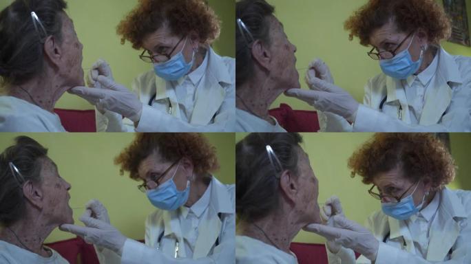 口罩医疗专业人员在家中向患病的老年患者注射咽拭子。快速抗原测试分析样本新型冠状病毒肺炎，冠状病毒养老