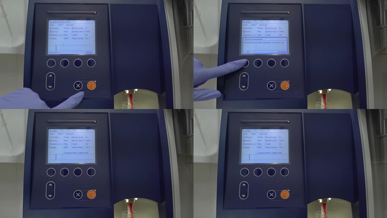 实验室助理按下终端实验室谷物测试仪的启动按钮