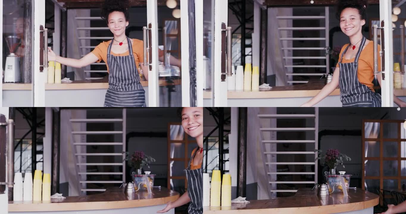 4k视频片段，一位迷人的年轻咖啡师以热情的方式打开了咖啡馆的门