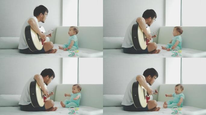 亚洲年轻的父亲和可爱的小男孩儿子坐在床上一起弹吉他。假期快乐的家庭。