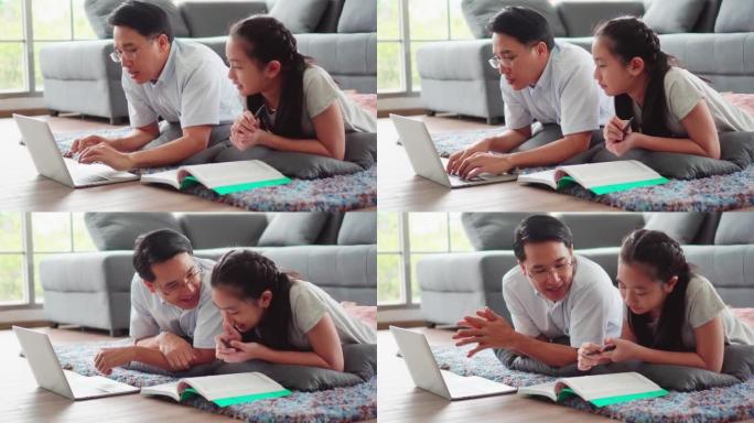 4k年轻的亚洲爱情家庭父女在家客厅沙发附近的一楼教作业，微笑着快乐。新型冠状病毒肺炎情况下的居家生活