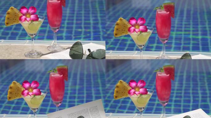 游泳池边的西瓜鸡尾酒和菠萝鸡尾酒，带书籍和太阳镜，度假