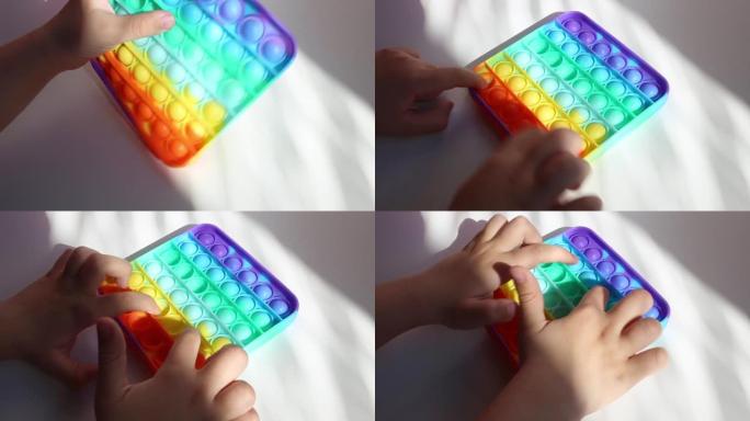 儿童玩彩色彩虹抗压力烦躁推流行儿童感官玩具。简单的酒窝。