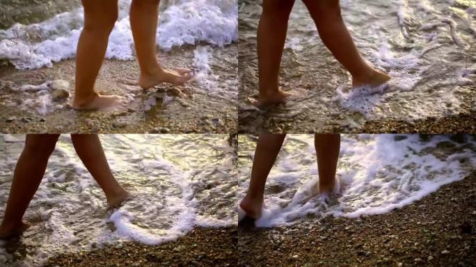 女性的腿沿着海边行走。一个女孩走路