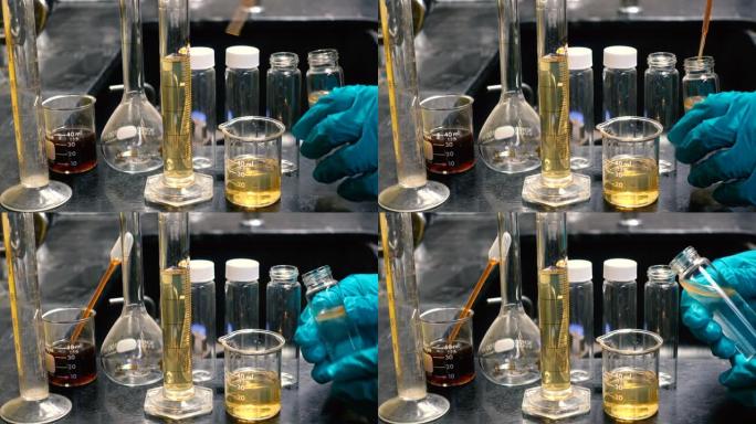 化学家在实验室实验中混合化学物质进行实验室测试，以发现试管中的颗粒含量或溶液。化学和石油概念