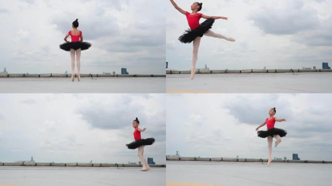 红色连衣裙和黑色裙子的芭蕾舞女孩在大城市的屋顶或高楼露台上跳舞