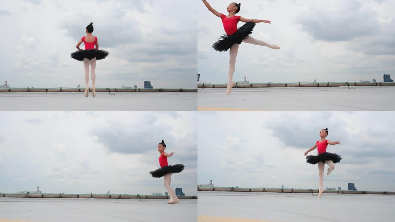 红色连衣裙和黑色裙子的芭蕾舞女孩在大城市的屋顶或高楼露台上跳舞