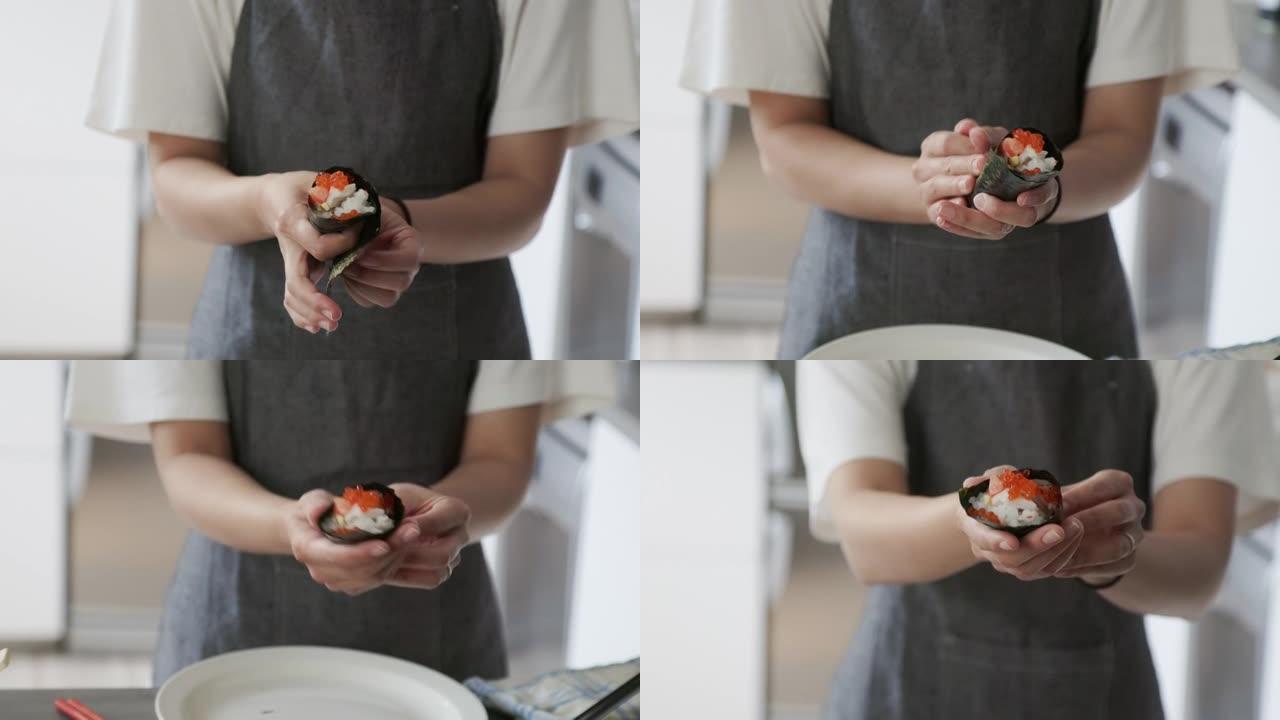 日本女性视频记录器在她的虚拟烹饪课活动中制作temaki寿司卷