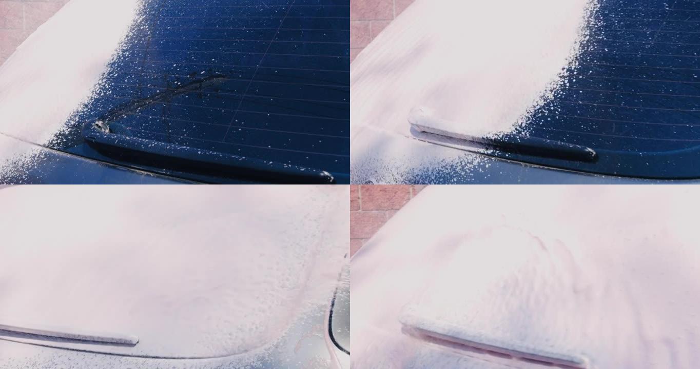 在洗车服务中使用泡沫用高压水射流清洗车窗。汽车细节概念
