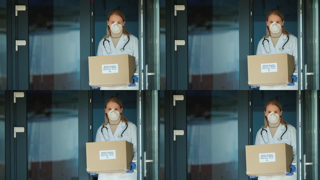 女医生手持装有防护医用口罩的盒子