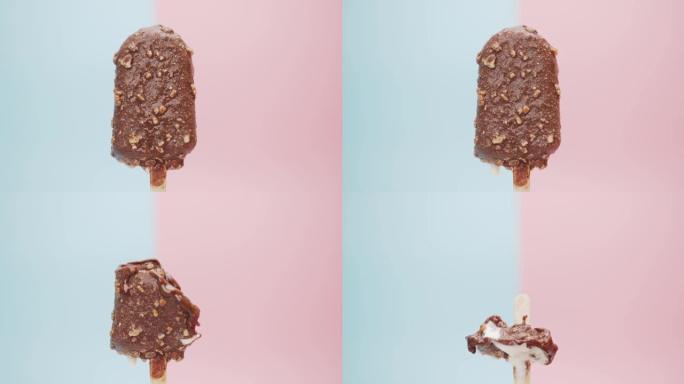 融化的巧克力冰淇淋棒孤立在蓝色粉色背景上。