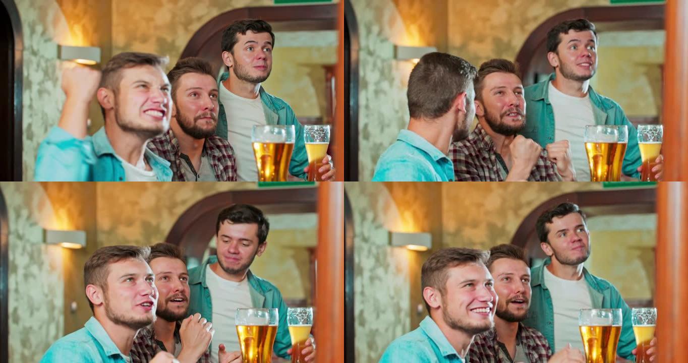 镜头特写镜头有魅力的帅哥在酒吧里一边喝啤酒一边看电视上最喜欢的比赛，他们非常专注和兴奋
