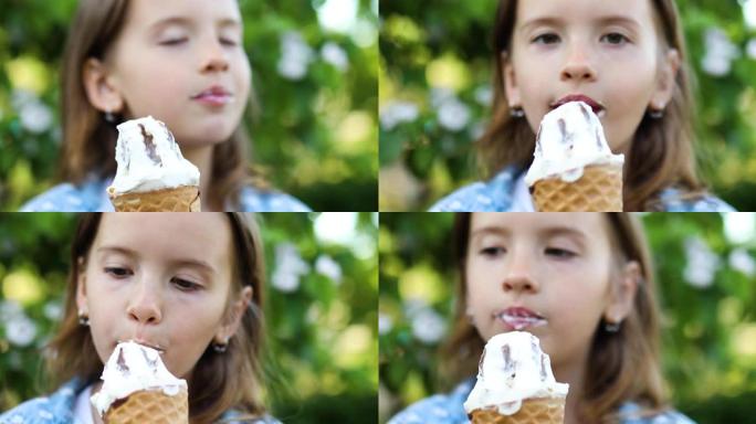 可爱的女孩在夏天在公园休息时吃意大利冰淇淋蛋卷微笑