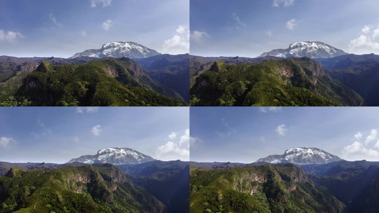 4k无人机镜头捕捉乞力马扎罗山及其周围的山谷和森林。自然、环境、探索、徒步旅行概念。