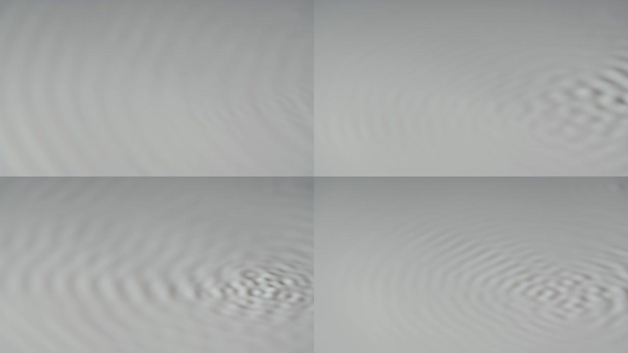 在牛奶的白色表面上形成了Cymatic图案。使用乳白色液体和声音频率创建纹理的艺术。慢动作。特写