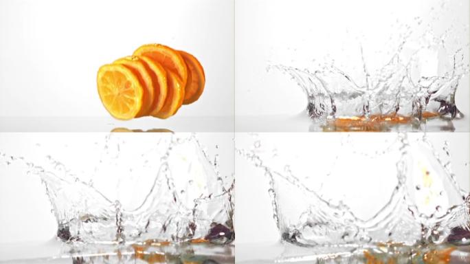 超级慢动作圆形柠檬片溅入水中。以1000 fps的高速相机拍摄。