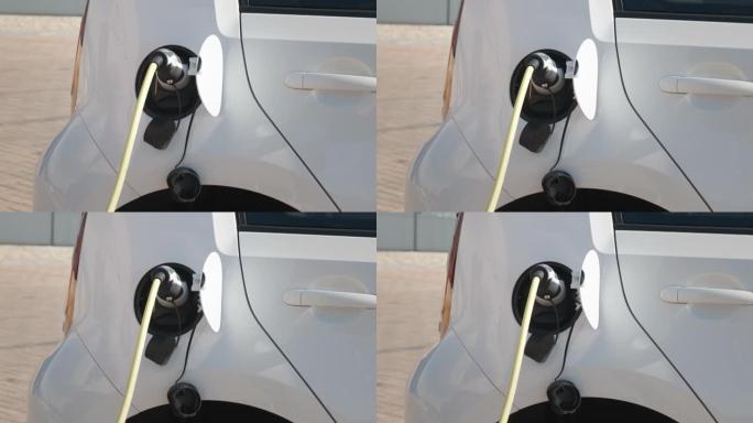 白色的ar在充电点的街道上充电。