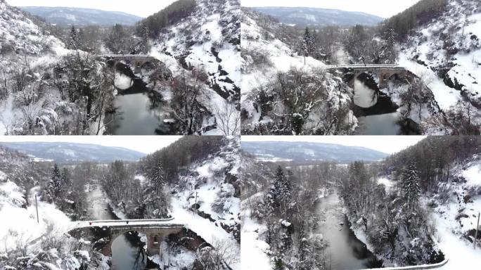 冬季，一名无人机操作员站在历史桥上的4k视频
