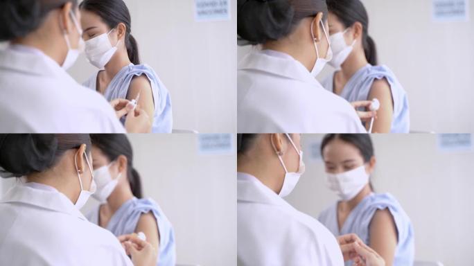 在诊所或医院近距离接种covid疫苗的肩部妇女，与护手注射疫苗以获得免疫力以保护病毒。戴着防护面具的