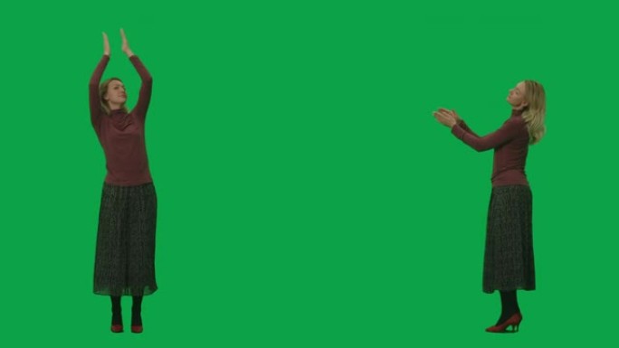 一个穿着长裙和高领毛衣的年轻女子的肖像，跳舞并拍手。绿屏背景上的2合1拼贴正面和侧面视图全长。慢动作