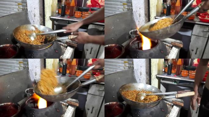 烹饪亚洲面条，在热锅中搅拌，中国快餐店，厨师在印度制作了拉面工艺。