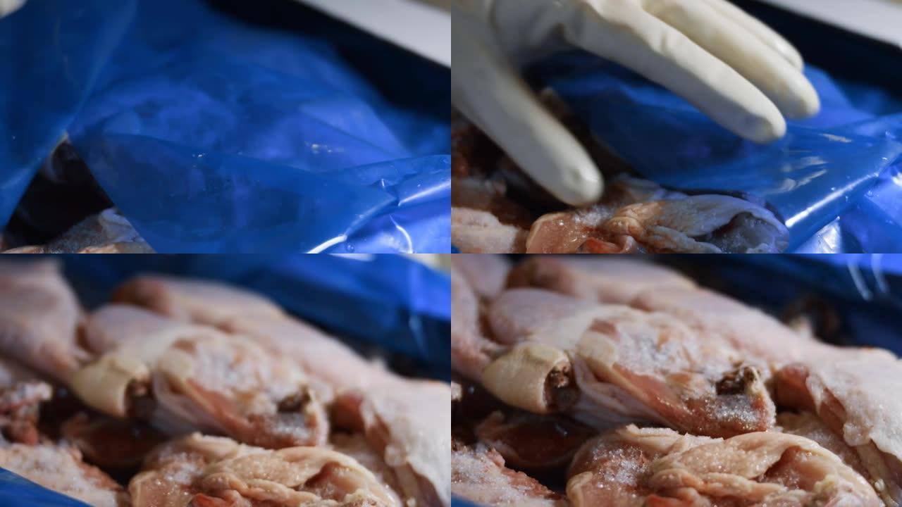 手套打开装满冷冻鸡腿的盒子的宏观视图。用冰覆盖的冷冻生鸡肉。4k视频
