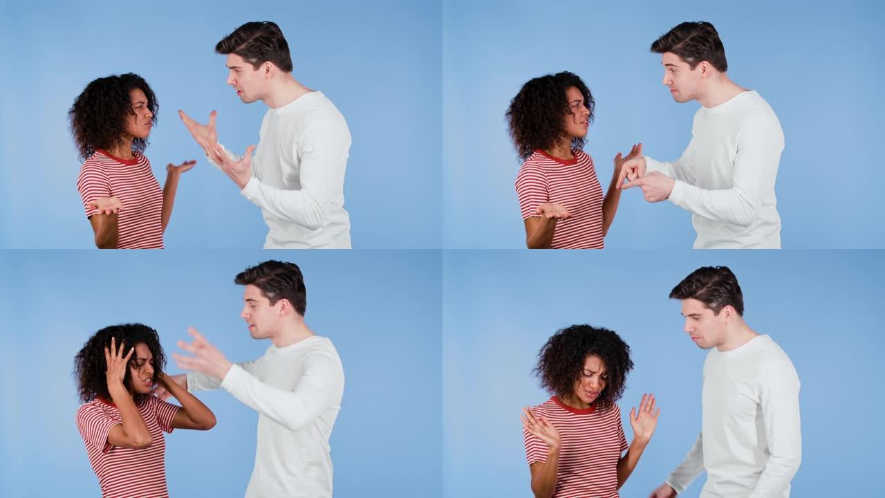 年轻的跨种族夫妇在蓝色背景上情绪争吵。冲突的概念，关系中的问题。非裔美国妇女和白人男子。
