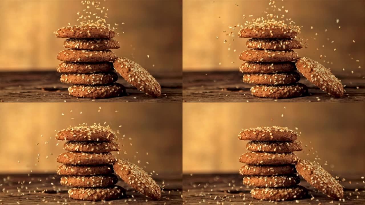 超级慢动作在一堆燕麦饼干上落下芝麻。以1000 fps的高速相机拍摄。