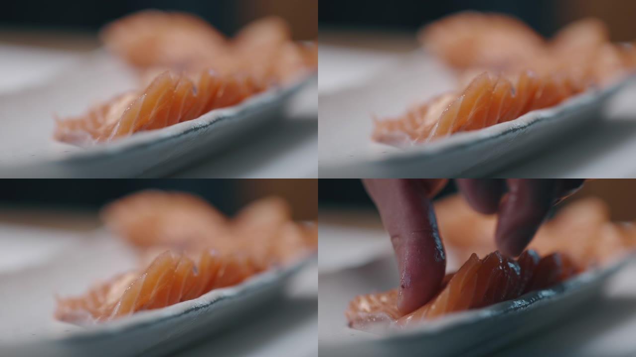 日本厨师切切生鲑鱼以制作寿司