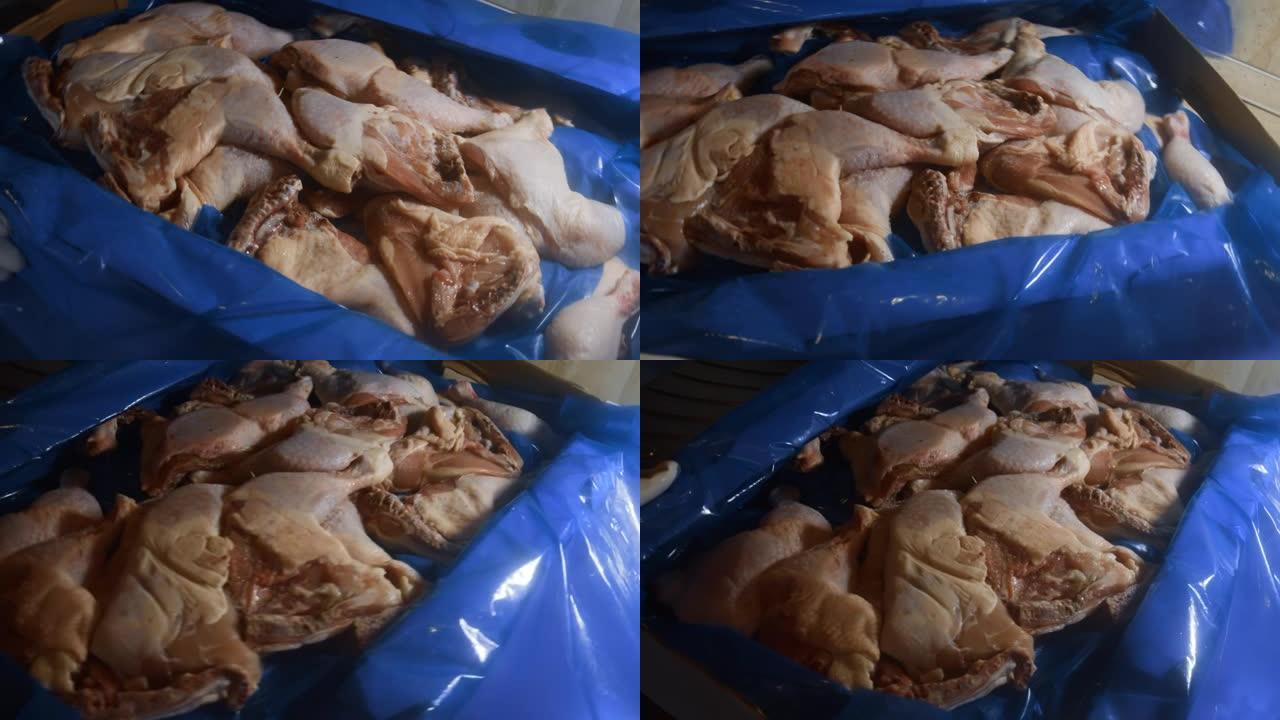 一个装满冷冻鸡腿的盒子的特写视图。用冰覆盖的冷冻生鸡肉。轮动。4k视频