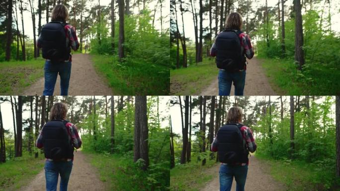 背着背包的人在森林里散步。