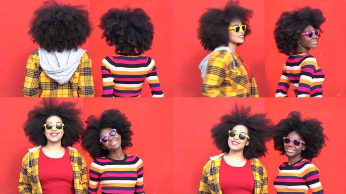 4k视频美丽的非洲裔美国妇女，非洲头发，太阳镜和彩色衣服在红色背景前微笑