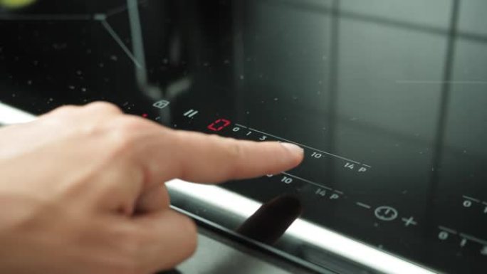 按下电磁炉上的启动按钮。预热厨房炉灶。用炉灶上的触摸按钮加热温度。手指按下滚刀上的电子触摸按钮。感应