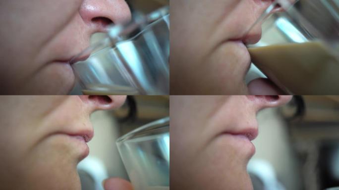 女人的嘴巴在餐厅或咖啡店里从杯子里喝咖啡的特写镜头