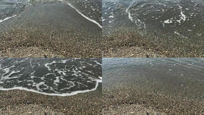 在旅游爱琴海小镇 “Sigacik” 的 “Akarca” 海滩上的爱琴海小浪和鹅卵石的镜头。这是土