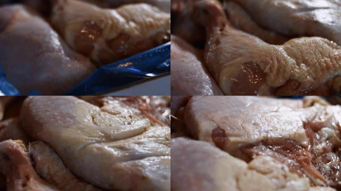 一个装满冷冻鸡腿的盒子的宏观视图。用冰覆盖的冷冻生鸡肉。4k视频