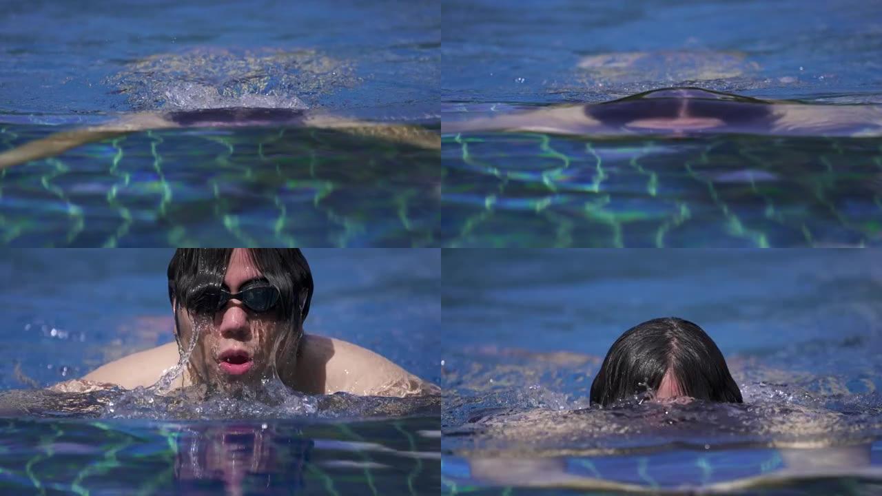 SLO MO-男子在游泳池里游泳蛙泳的特写镜头，看着相机