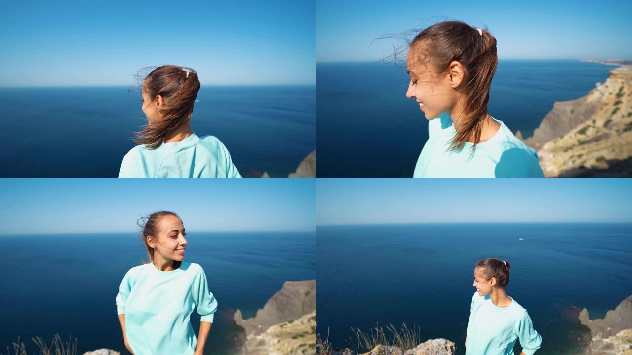 一个年轻女子站在海边的高崖边，享受着阳光明媚的夏日早晨