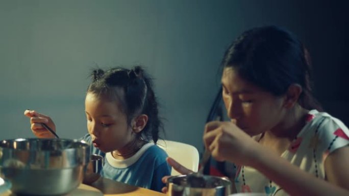 快乐的亚洲男孩和女孩晚上在家一起吃晚餐，生活方式理念。