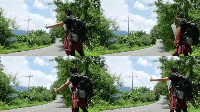 在泰国迷人的风景自然中，暑假旅行期间，旅行妇女在路边背包搭便车。旅行和搭便车的概念。